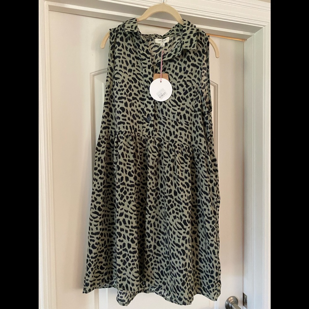 Green black print dress with buttons on top half.